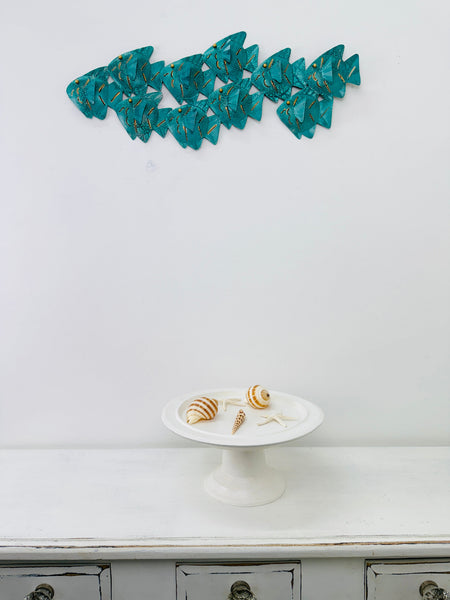 Display view of turquoise crackle metal fish shoal showing gold details
