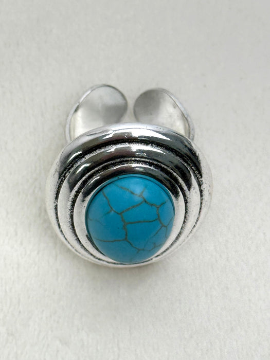 Silver ring with a turquoise stone on a white background