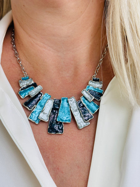 Geometric enamel necklace with layered rectangular pieces in turquoise, grey and gunmetal, on silver-tone chain