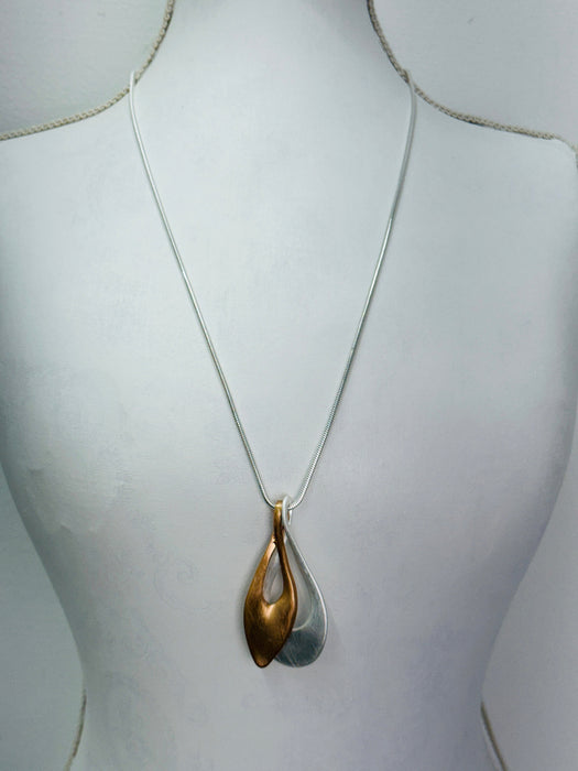 Necklace with a double-layered pendant on a mannequin bust.