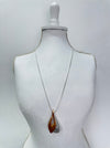 two tone gold silver drop pendant necklace displayed on a mannequin