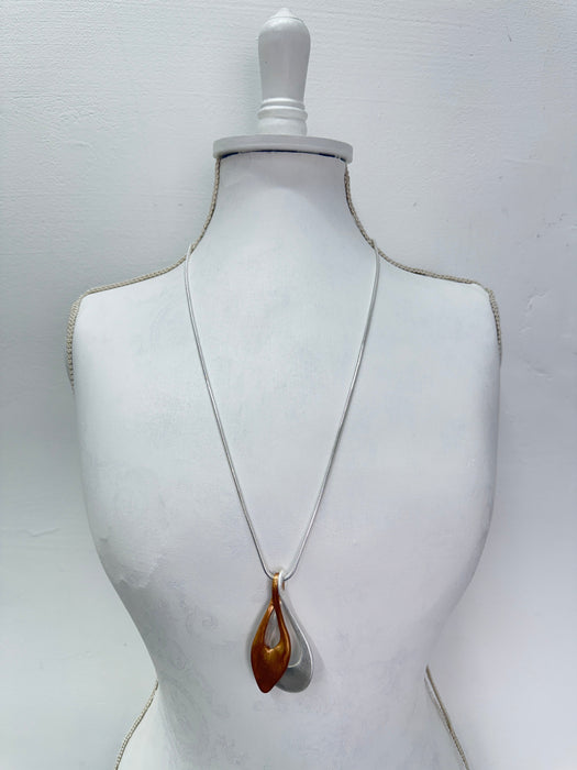 two tone gold silver drop pendant necklace displayed on a mannequin