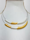 close-up of necklace with gold and silver curved design 