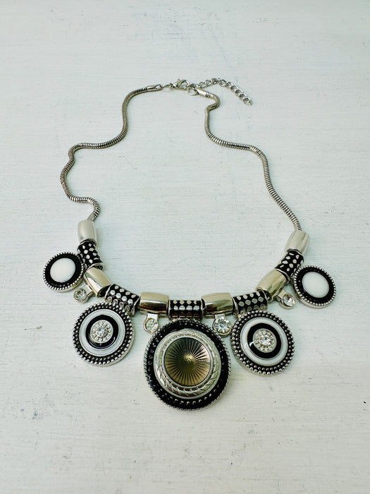 Necklace with circular designs on a light gray background