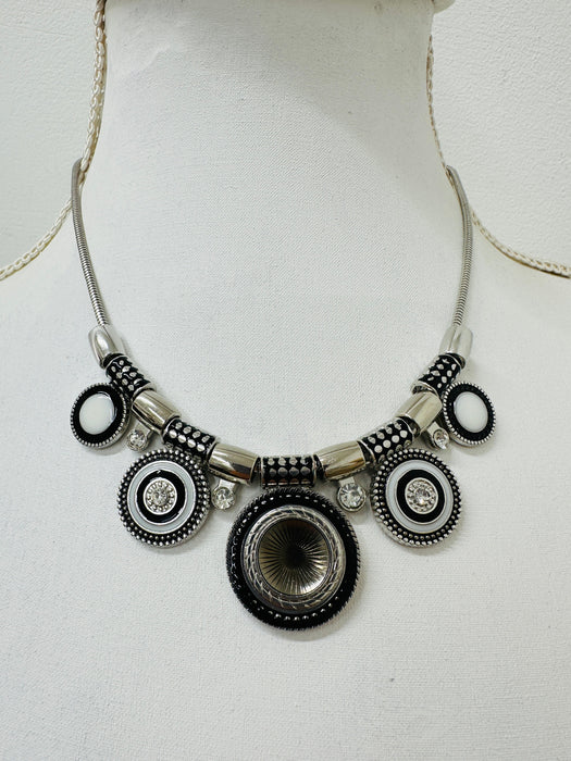 An elegant silver tone necklace with an enamelled detail, clear faceted crystals on a snake style chain, with a lobster clasp fastening and extender.