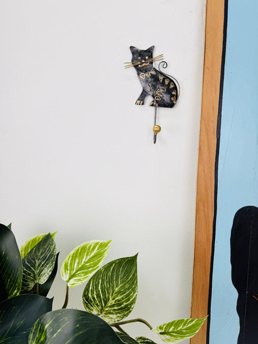 Handmade cat wall hook styled with plants.