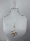 Necklace with a floral pendant on a mannequin bust against a plain background