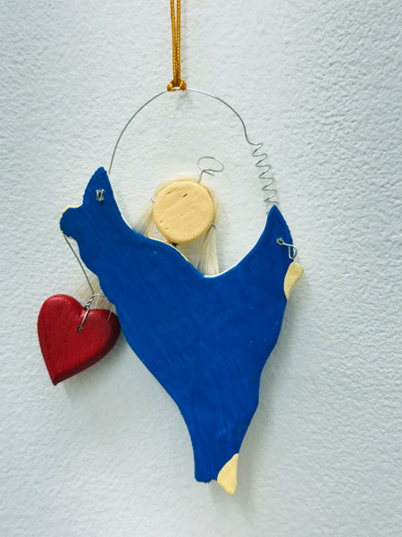 Back of the blue angel Christmas ornament showing hanging loop and plain finish.