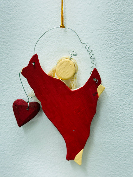 Back of the red angel Christmas ornament showing hanging loop and plain finish.