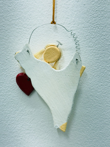 Back of the white angel Christmas ornament showing hanging loop and plain finish.