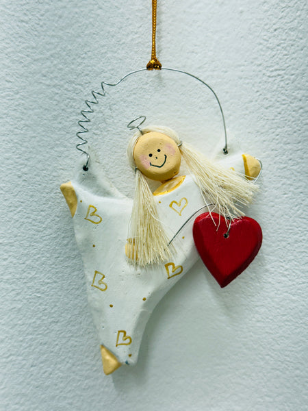 Hand-painted white angel with gold heart dress and red heart.