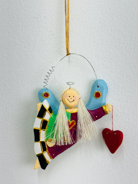 Handmade wooden decorative angel ornament with colourful dress and a heart. Comes with a gold string, displayed on a white background