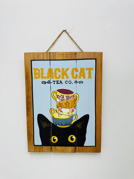 Hand-painted Black Cat wooden sign with coffee cup illustration and hanging rope on white background.