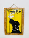 Hand-painted Black Dog wooden sign with coffee cup illustration and hanging rope on white background.