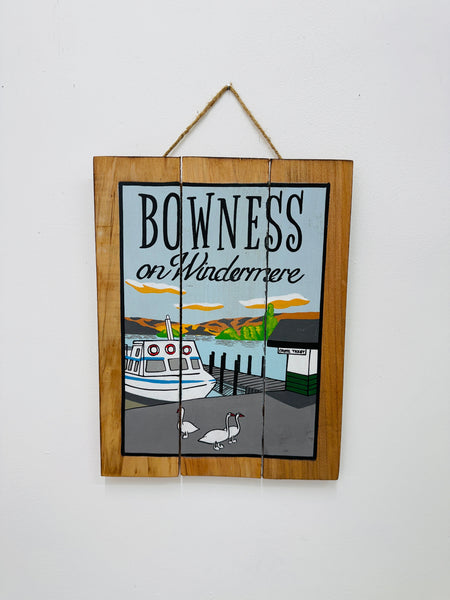 Hand-painted Bowness on Windermere wooden sign with lake illustration and hanging rope on white background.