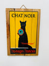 Hand-painted Chat Noir wooden sign with French cheese poster illustration and hanging rope on white background.