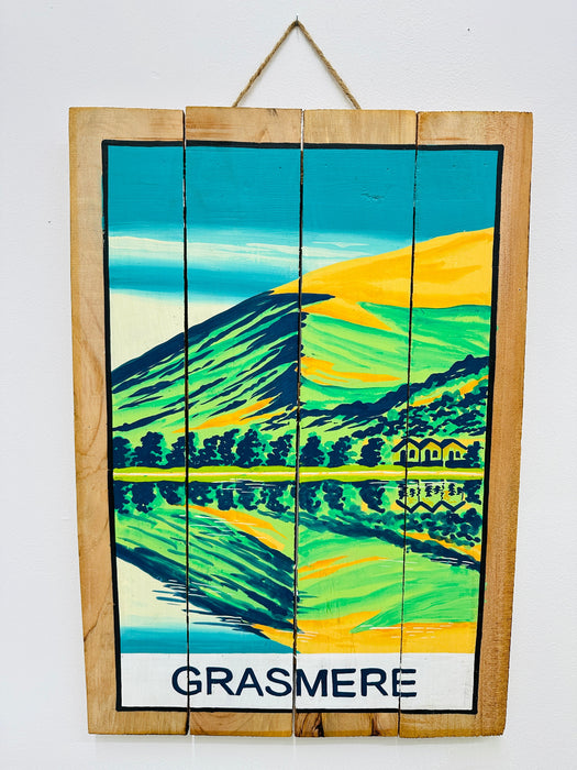 Hand-painted Grasmere wooden sign with mountain landscape illustration and hanging rope on white background.