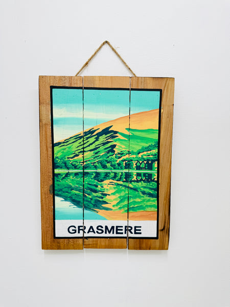 Hand-painted Grasmere wooden sign with mountain illustration and hanging rope on white background.