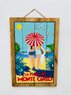 Hand-painted Monte Carlo wooden sign with French Riviera illustration and hanging rope on white background.