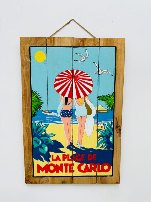 Hand-painted Monte Carlo wooden sign with French Riviera illustration and hanging rope on white background.