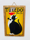 Hand-painted Tuxedo Cat wooden sign with tea cup illustration and hanging rope on white background.