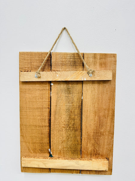 Back of Tuxedo Cat wooden sign showing natural wood panels and hanging rope.