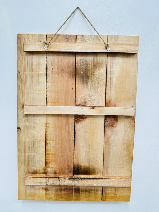 Back of Windermere wooden sign showing natural wood panels and hanging rope.
