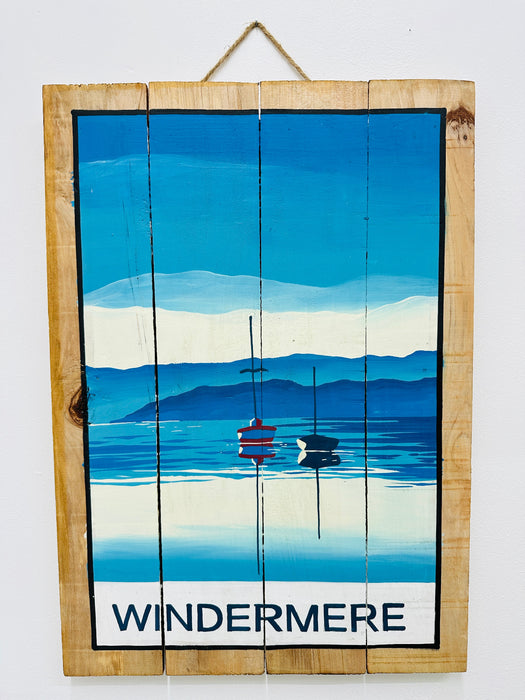 Hand-painted Windermere wooden sign with lake landscape illustration and hanging rope on white background.