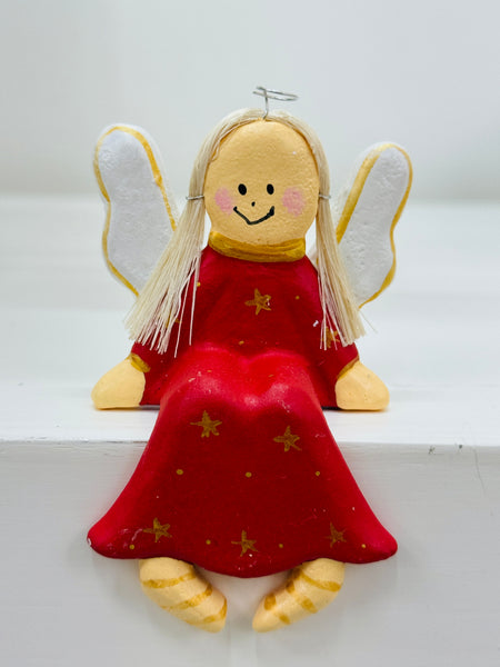 Sitting wooden angel in red with gold stars, shelf-sitter
