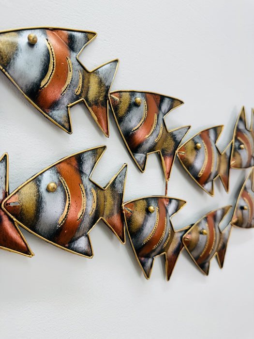 Close-up of hand-painted zebra fish detailing in mottled copper and gold tones.