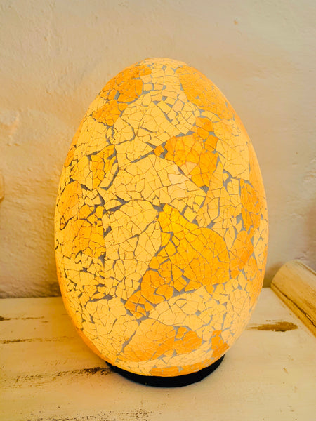 front view of mosaic egg lamp with light on