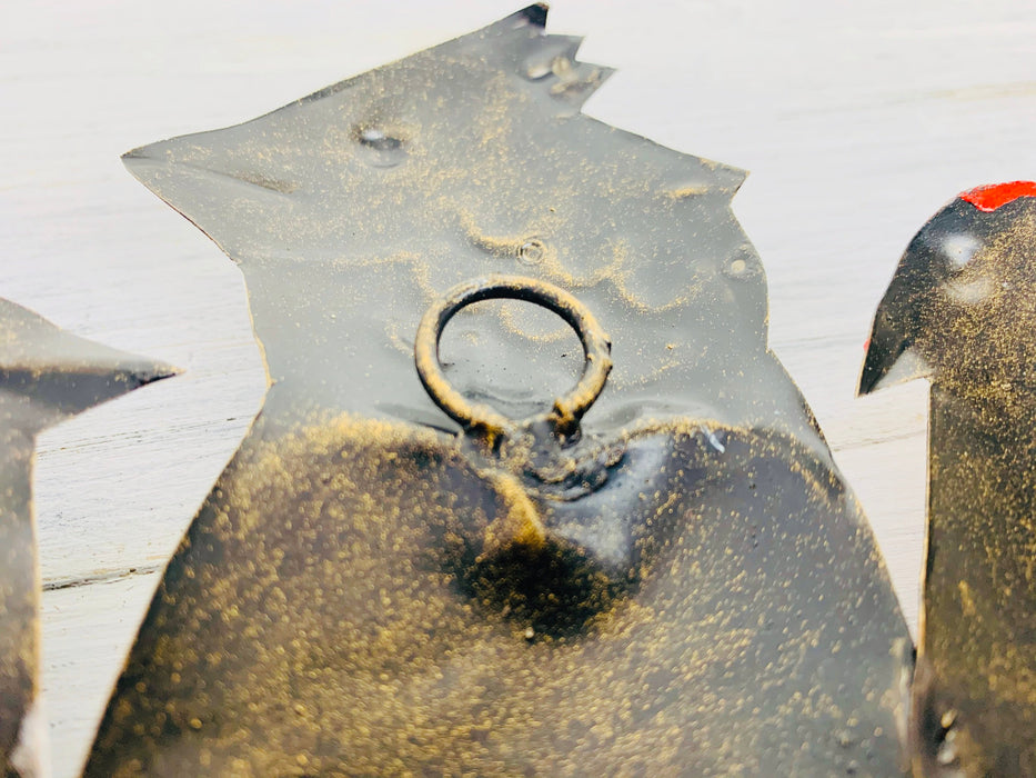 close up of the hook on the back of metal birds on a wire