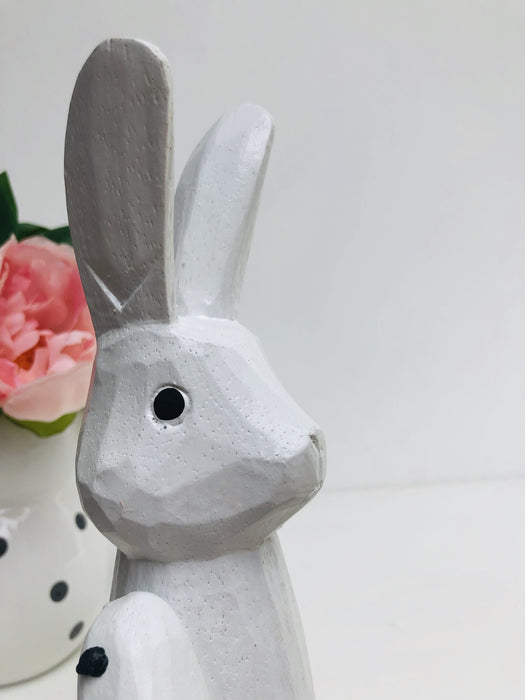 close up of wooden bunny in white