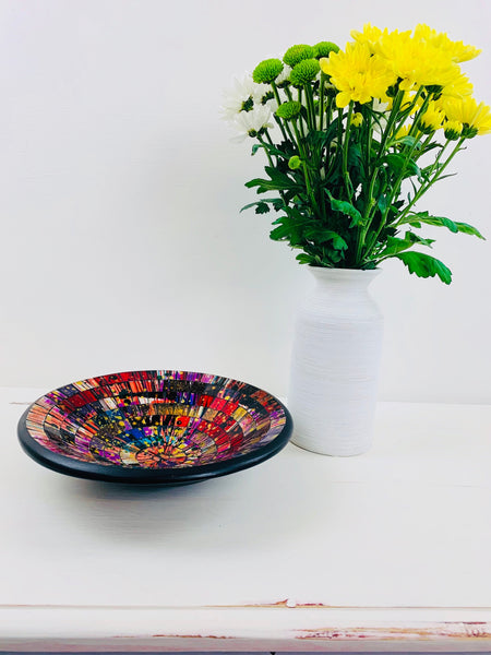 front view of mosaic bowl and a vase of flowers