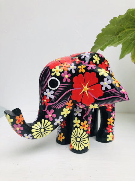 front view of black wooden flower elephant 