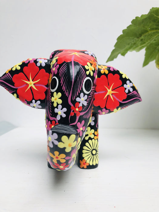 front view of black wooden flower elephant