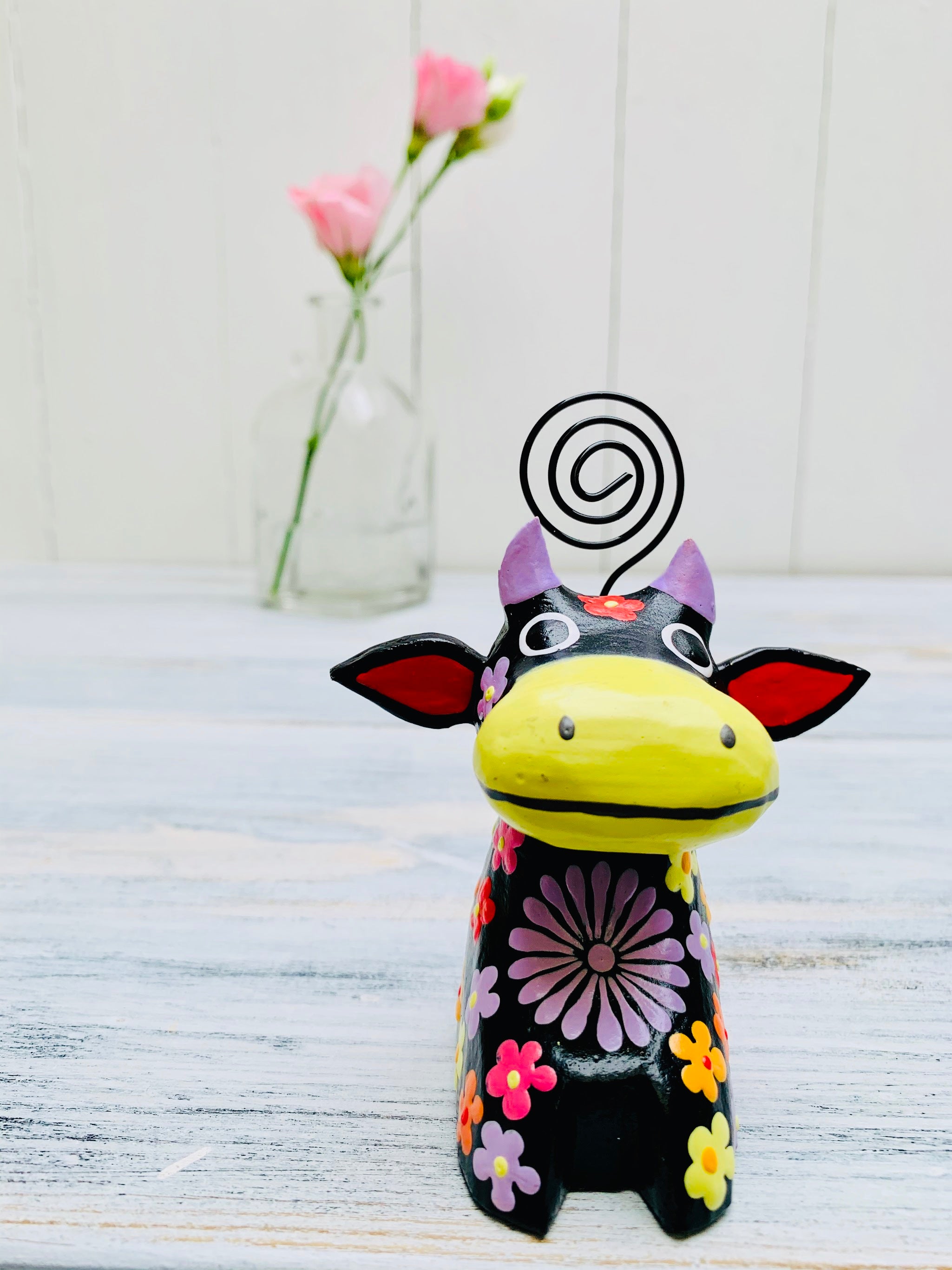 front view of wooden flower cow in black