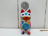 front view of white sitting flower kitty