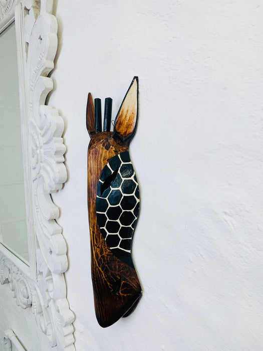 side view of wooden giraffe mask