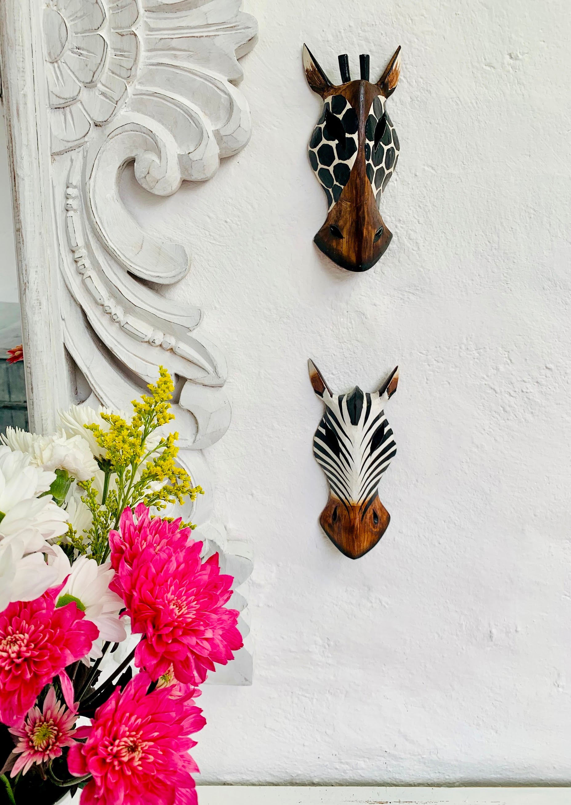 set display view of two zebra and giraffe wooden masks