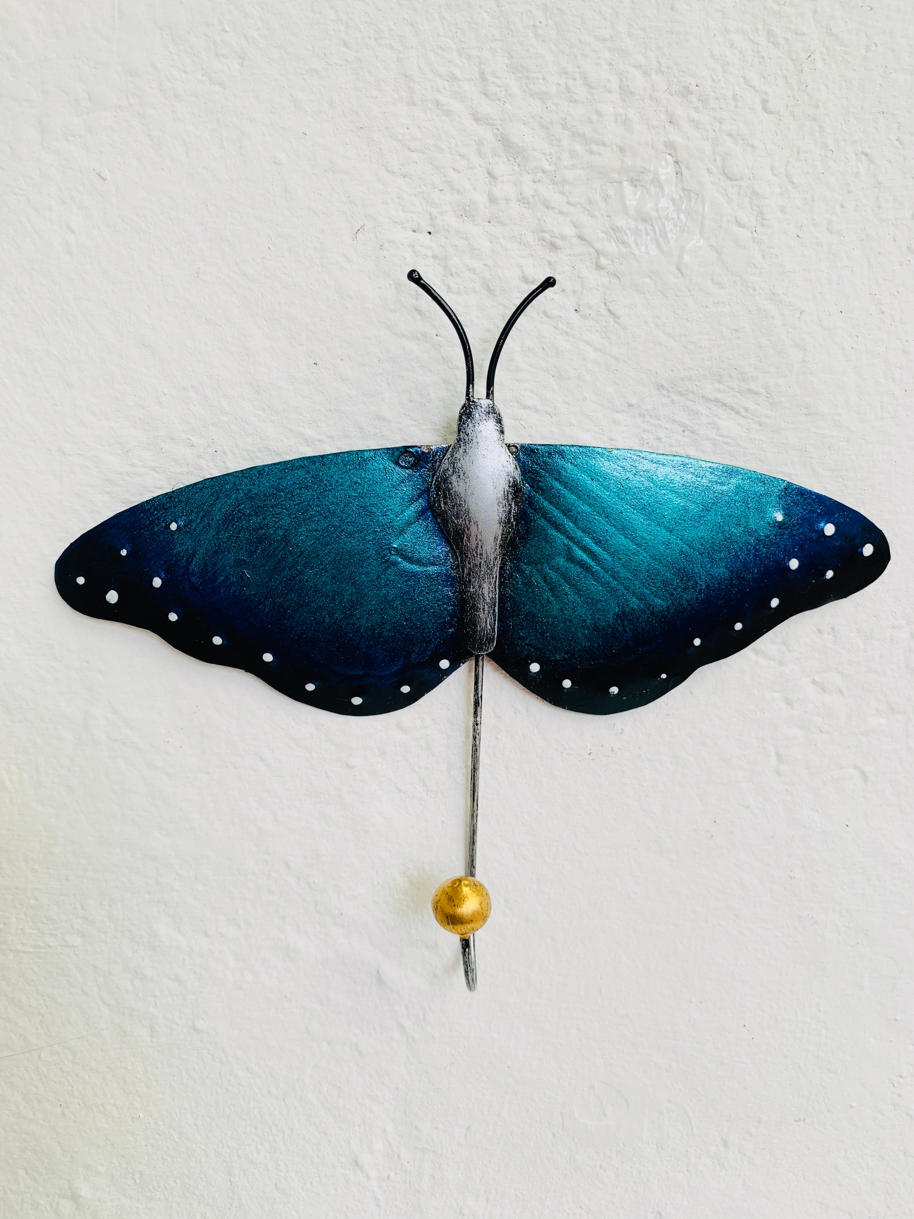 front view of metal butterfly hook in blue