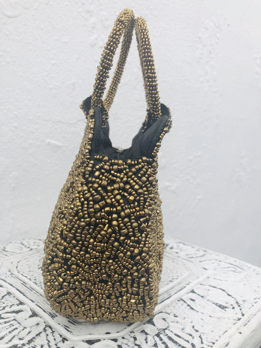 side view of gold beaded handbag