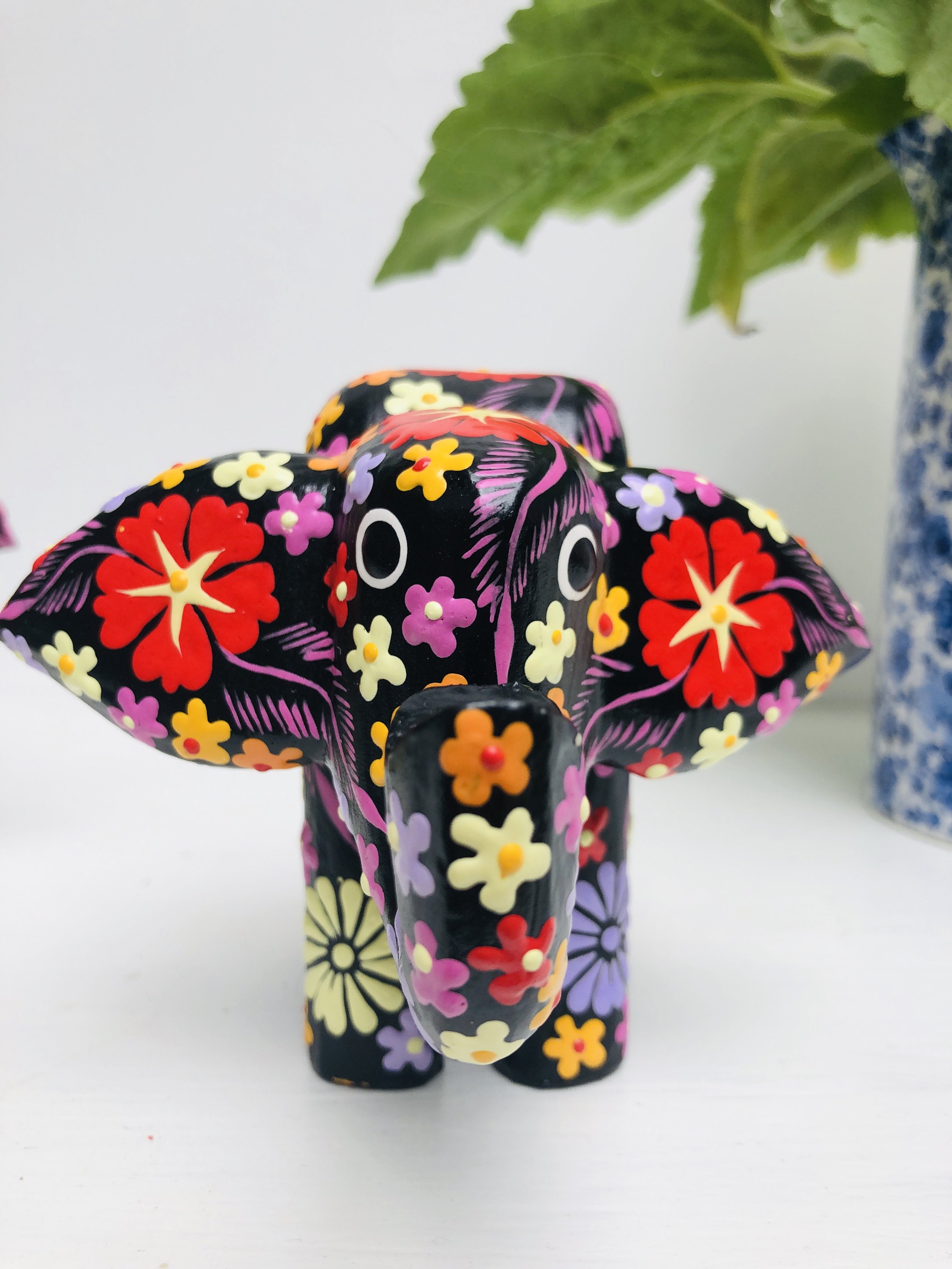 front view of black wooden flower elephant 