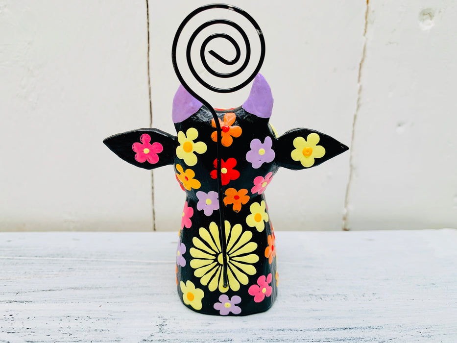 close up back view of wooden flower cow in black