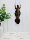 display view of wooden giraffe mask on wall