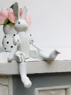 front view of wooden bunny sat on a white surface 