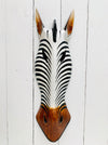 front view of zebra wood mask on white wall