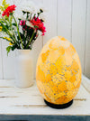front view of mosaic egg lamp with light on