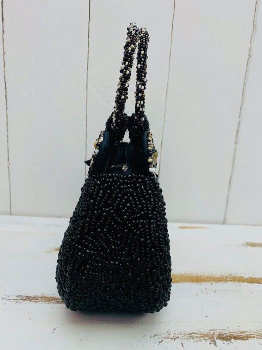 side view of beaded handbag in black