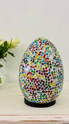 front view of mosaic egg lamp with light off on white surface